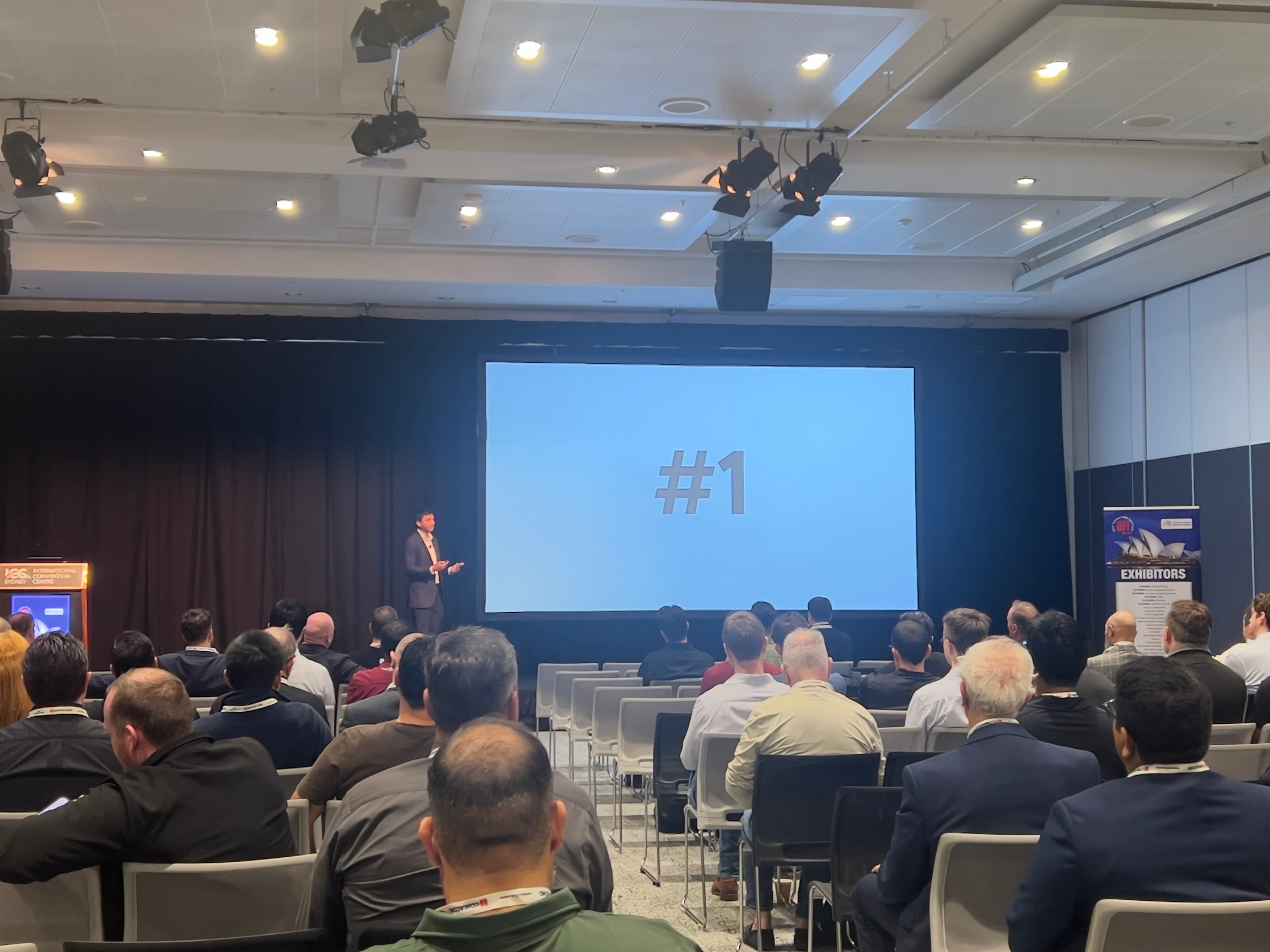 Tam presenting practical AI examples on stage