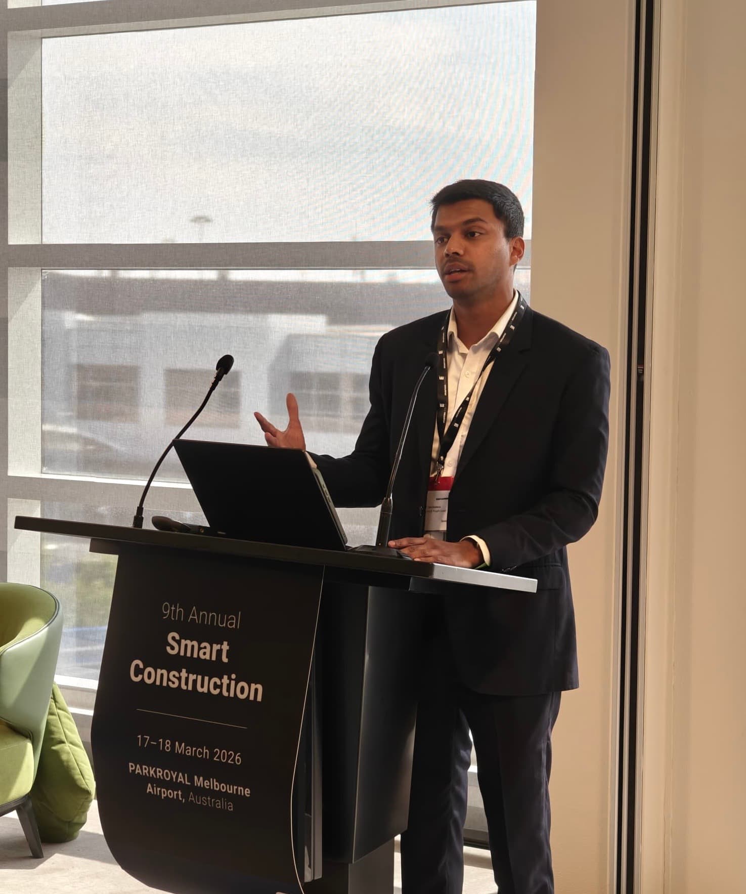 Tam presenting on stage at an industry conference