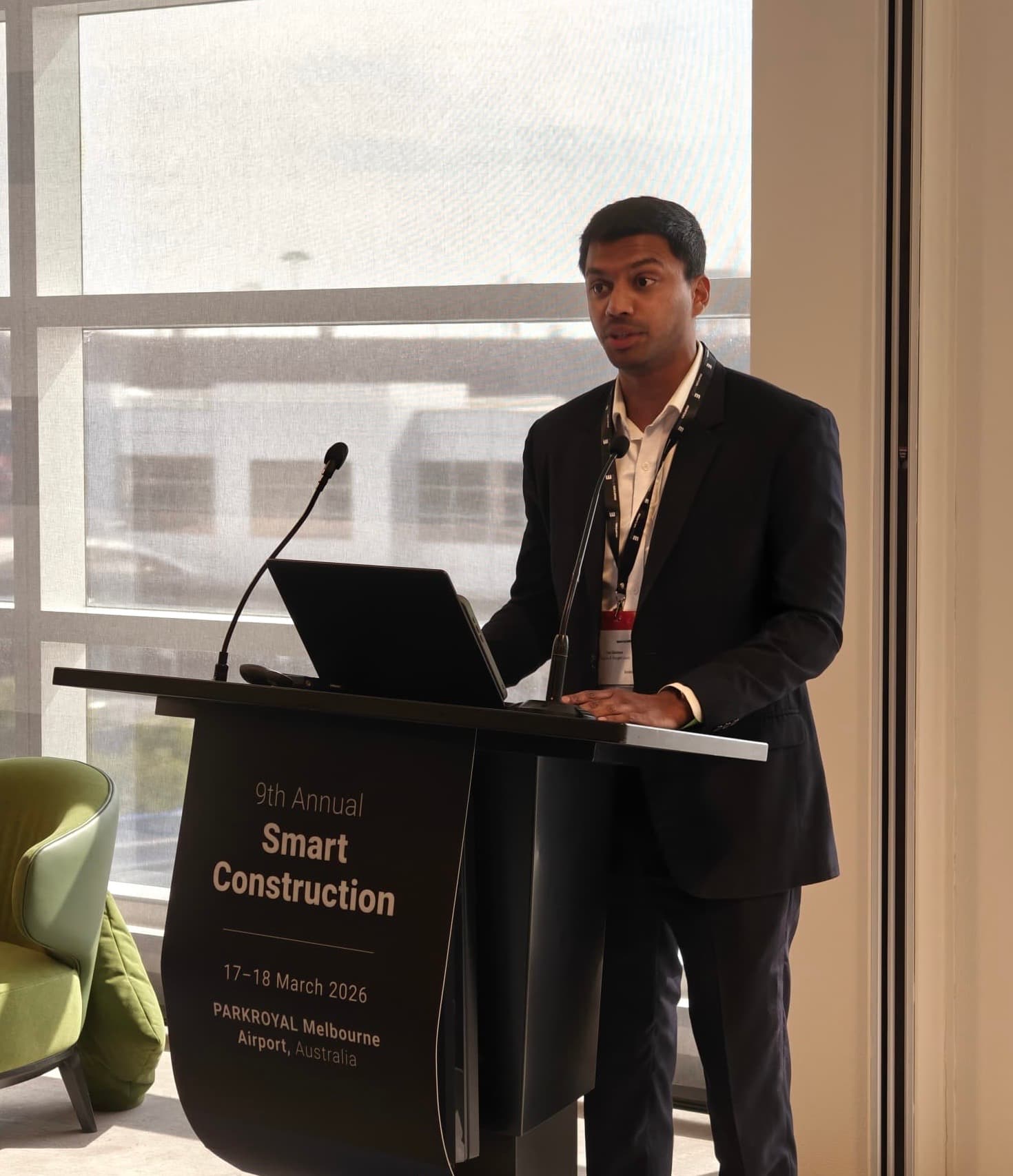 Tam speaking during a conference session